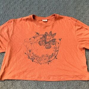 Orange waist length shirt with fairy design
